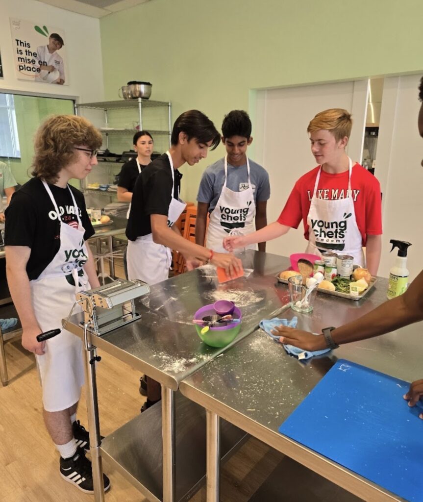 Homeschool cooking class students learning hands-on culinary skills at Young Chefs Academy in Maitland Florida
